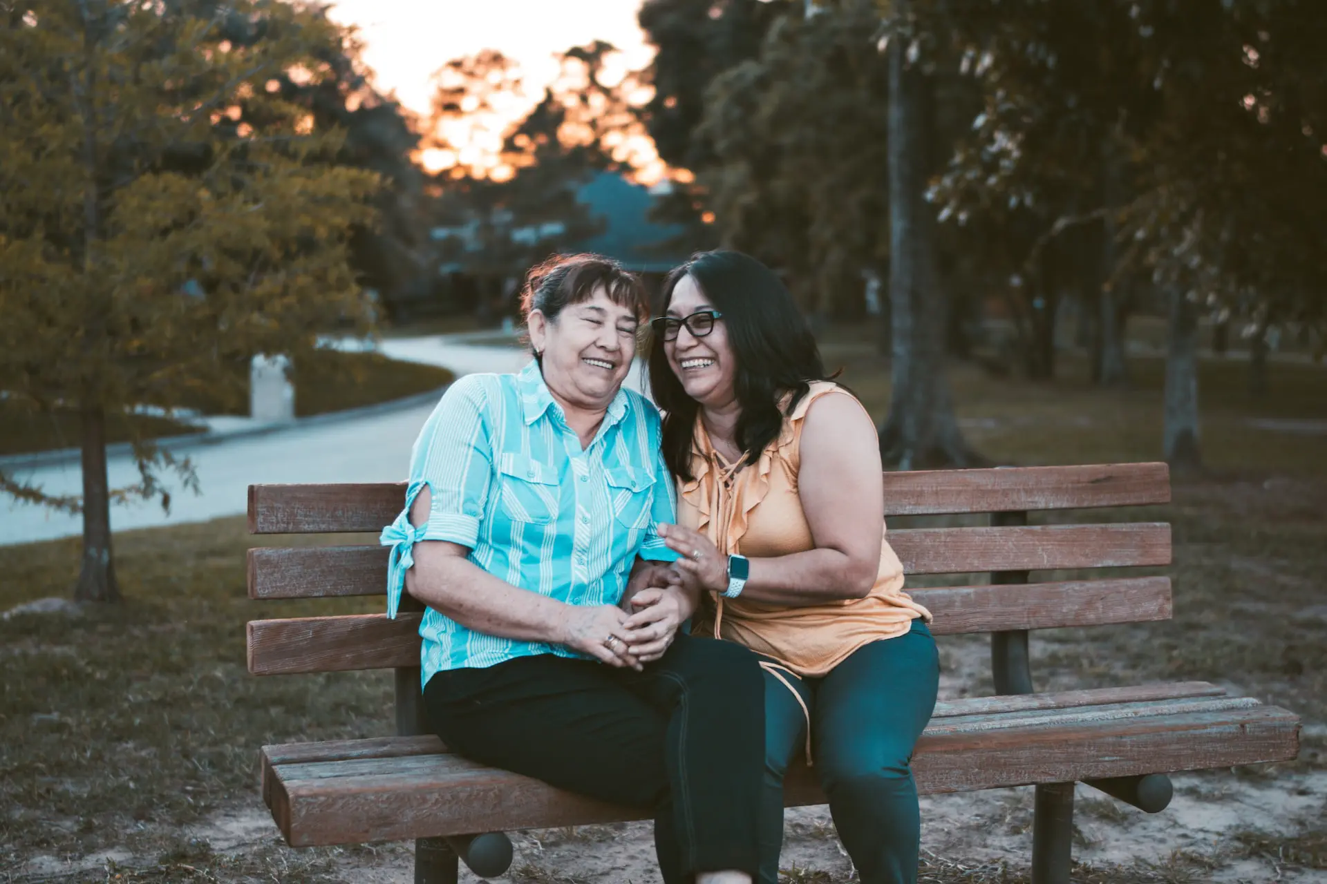 how long do teeth last - two women smiling on bench