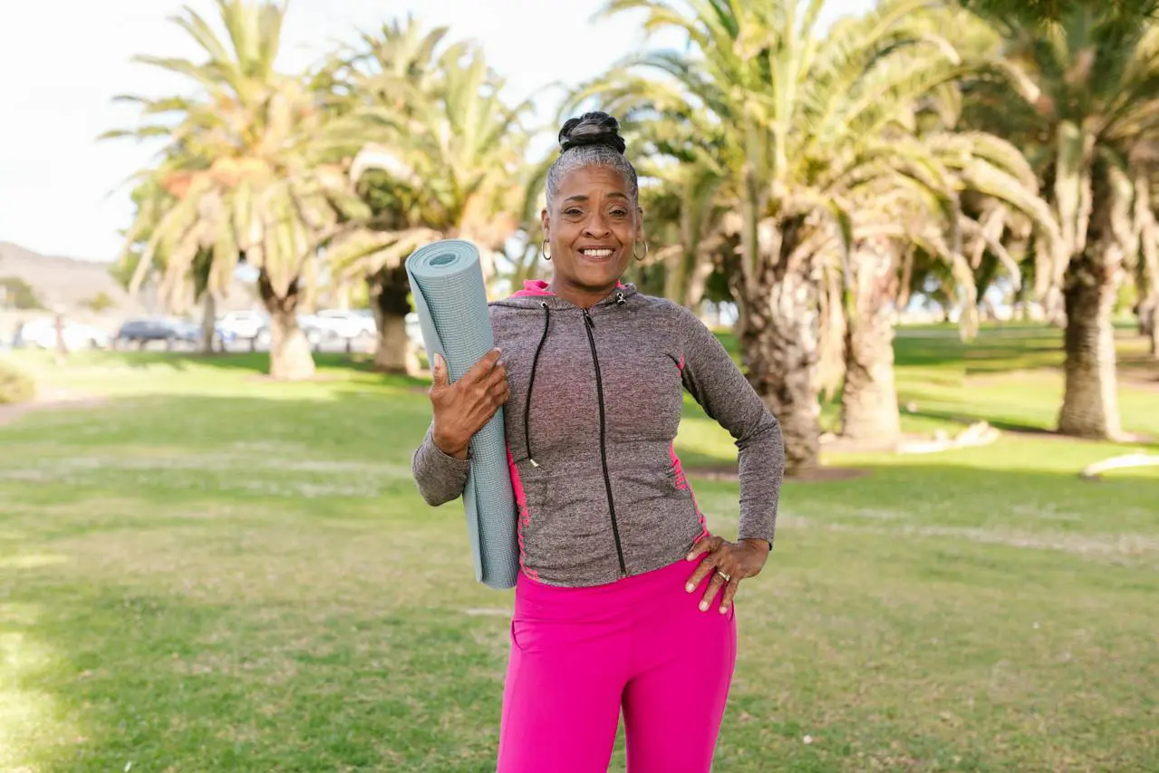 dentures vs. bridge; older woman smiling holding yoga mat