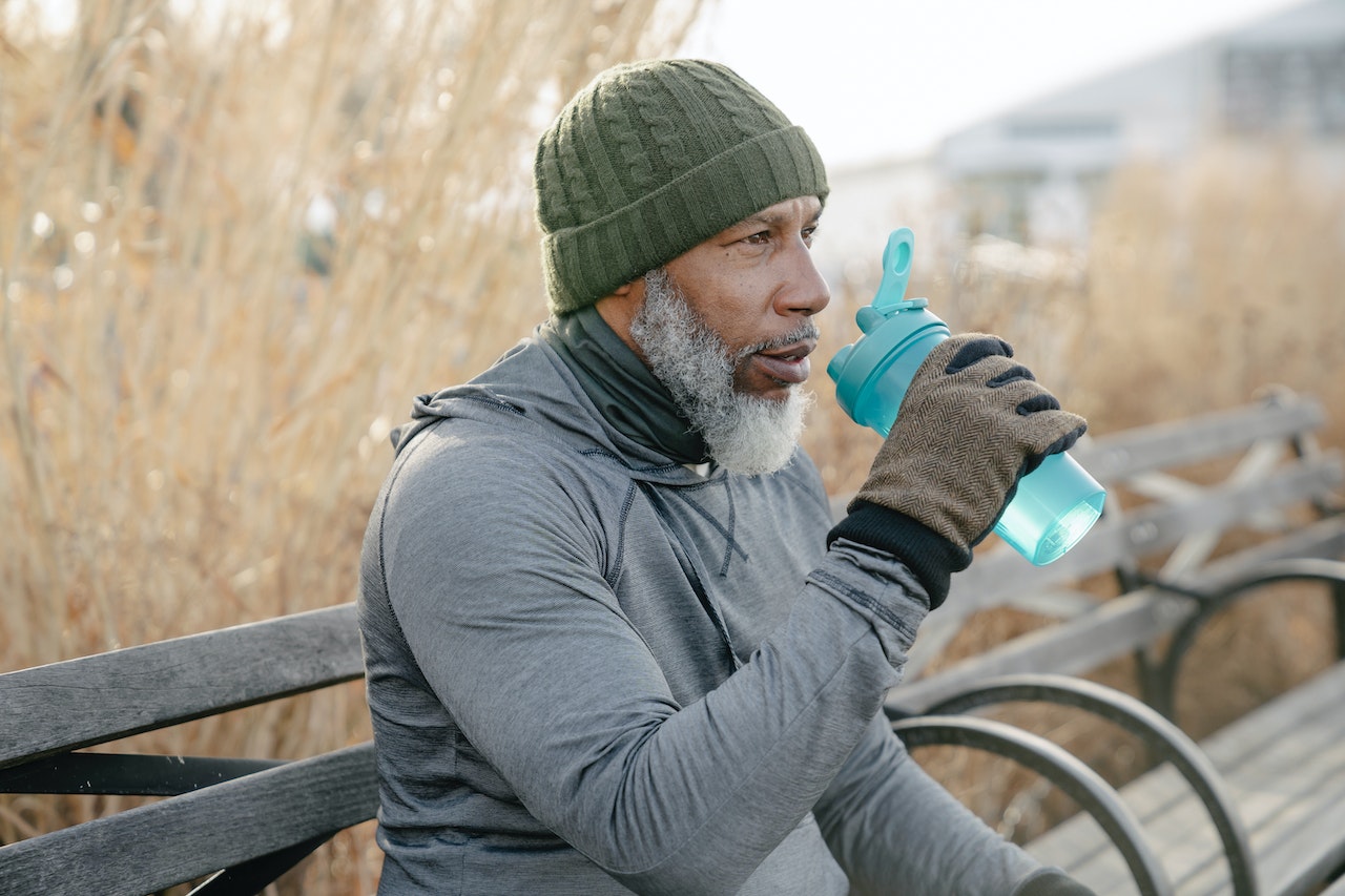 dry mouth remedies - man drinking water outside