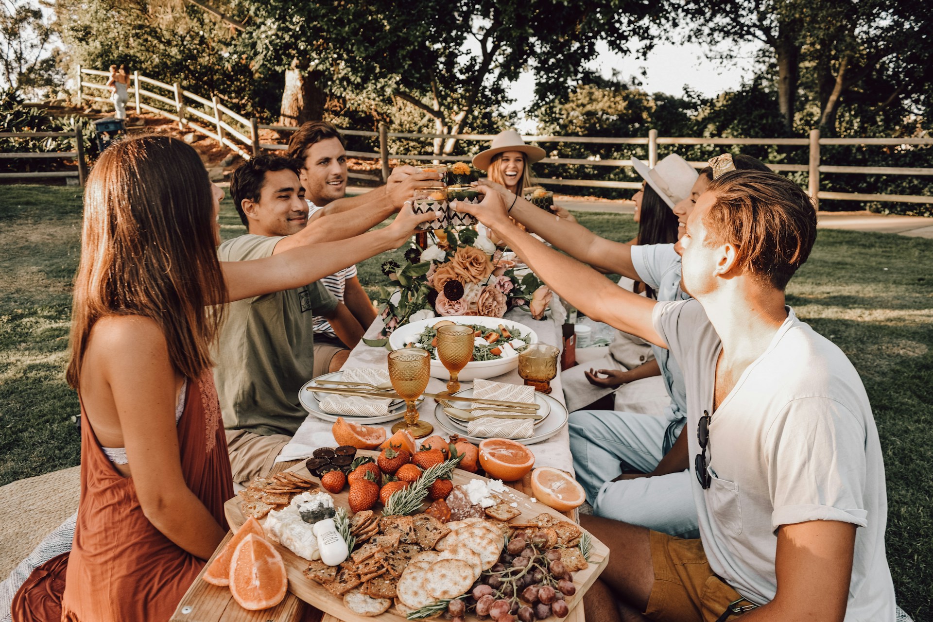 people sitting around a table with food and drink